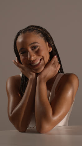 Studio-Beauty-Shot-Of-Young-Woman-With-Long-Braided-Hair-Sitting-At-Table-5